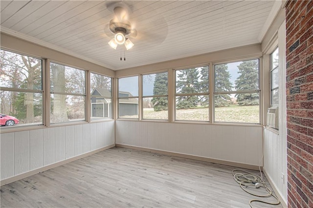 unfurnished sunroom featuring ceiling fan and plenty of natural light