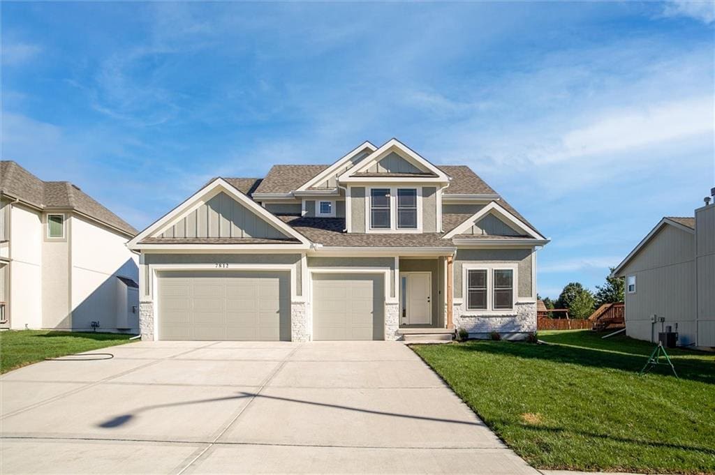 craftsman-style home with a front yard and a garage