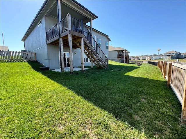 back of property with a yard and a deck