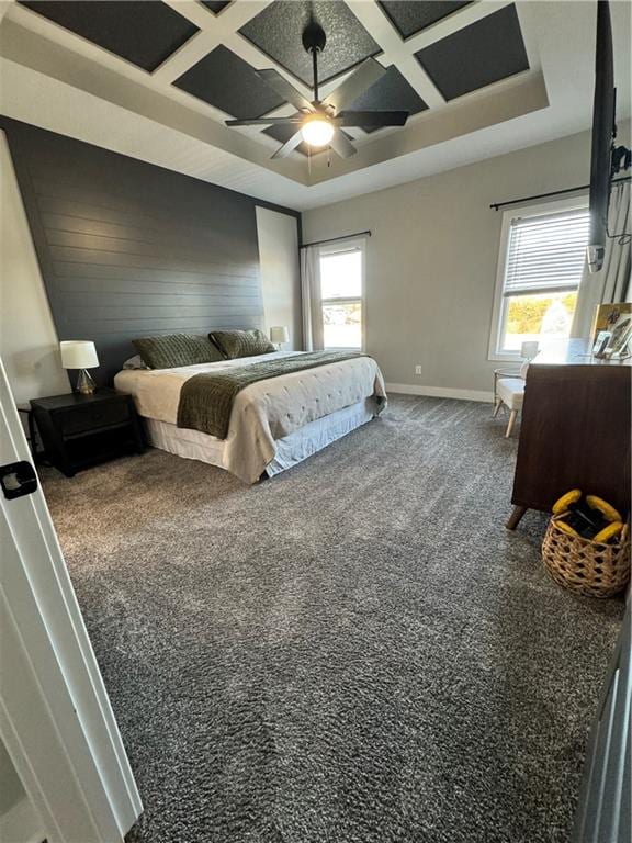 bedroom with coffered ceiling, multiple windows, ceiling fan, and carpet floors