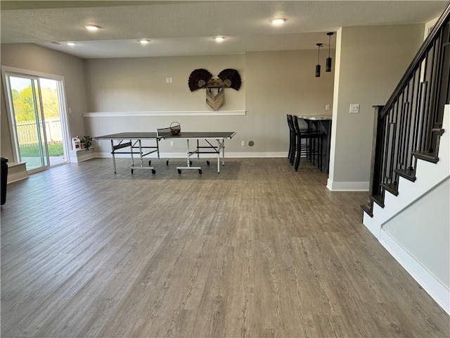 dining room with hardwood / wood-style floors and a textured ceiling