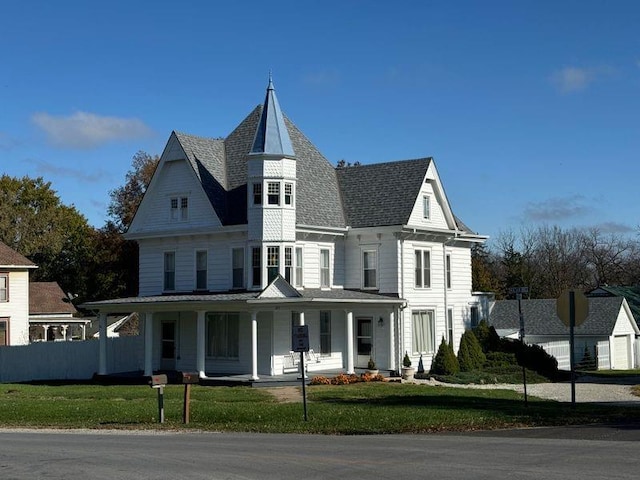 victorian-style house with a porch and a front yard