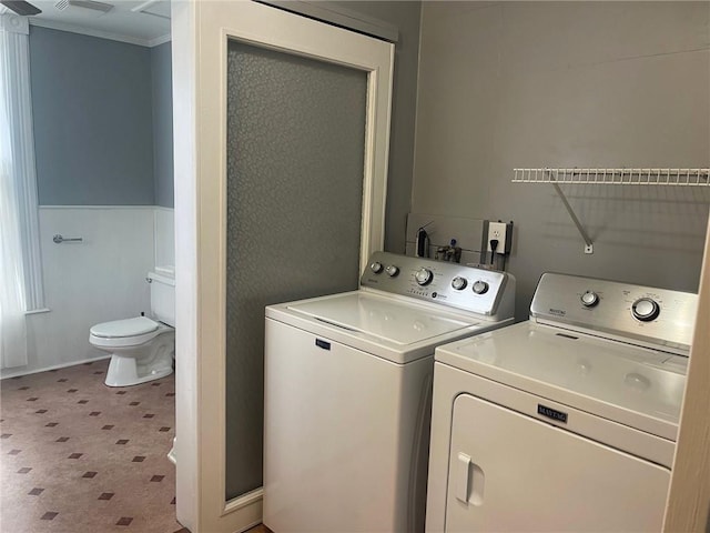 clothes washing area featuring washing machine and dryer and ornamental molding