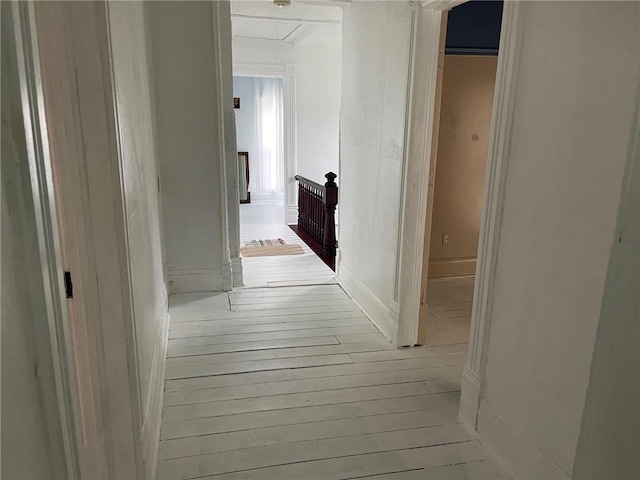 corridor with light hardwood / wood-style floors