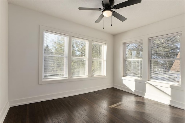 unfurnished room with dark wood-type flooring and ceiling fan