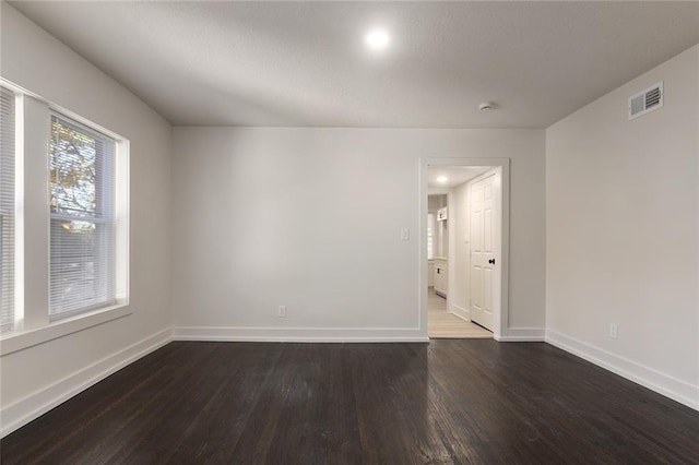 empty room featuring dark hardwood / wood-style flooring