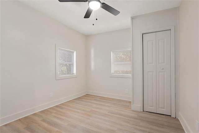 empty room with light hardwood / wood-style floors, ceiling fan, and plenty of natural light