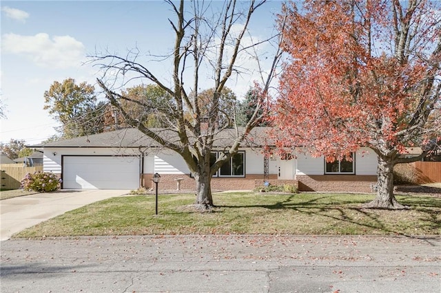 obstructed view of property featuring a garage and a front yard