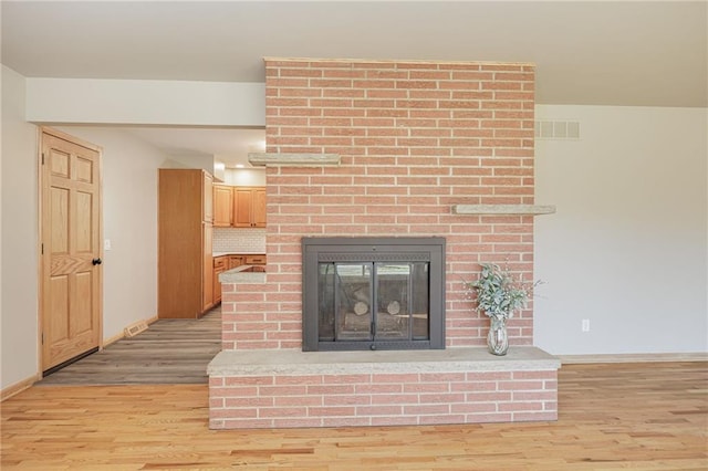 interior details featuring a fireplace and hardwood / wood-style flooring