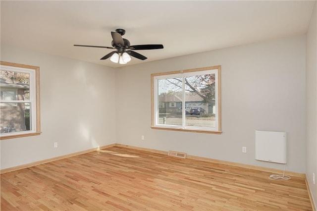 unfurnished room featuring light wood-type flooring and ceiling fan