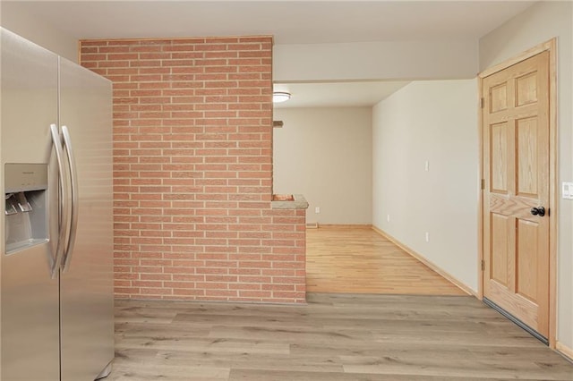 hallway with light hardwood / wood-style floors