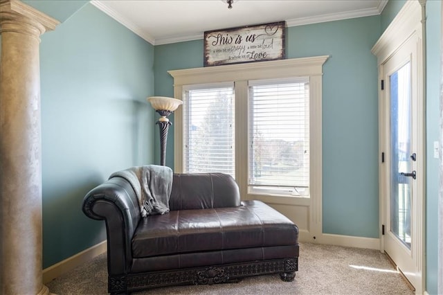 living area with decorative columns, light carpet, and ornamental molding