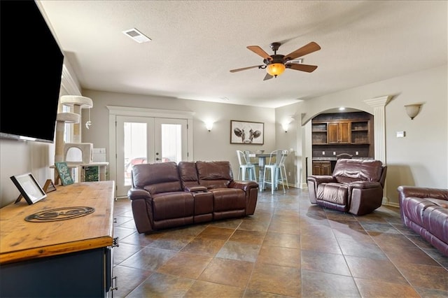 living room with french doors and ceiling fan