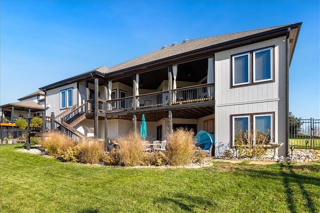 rear view of house with a yard and a deck