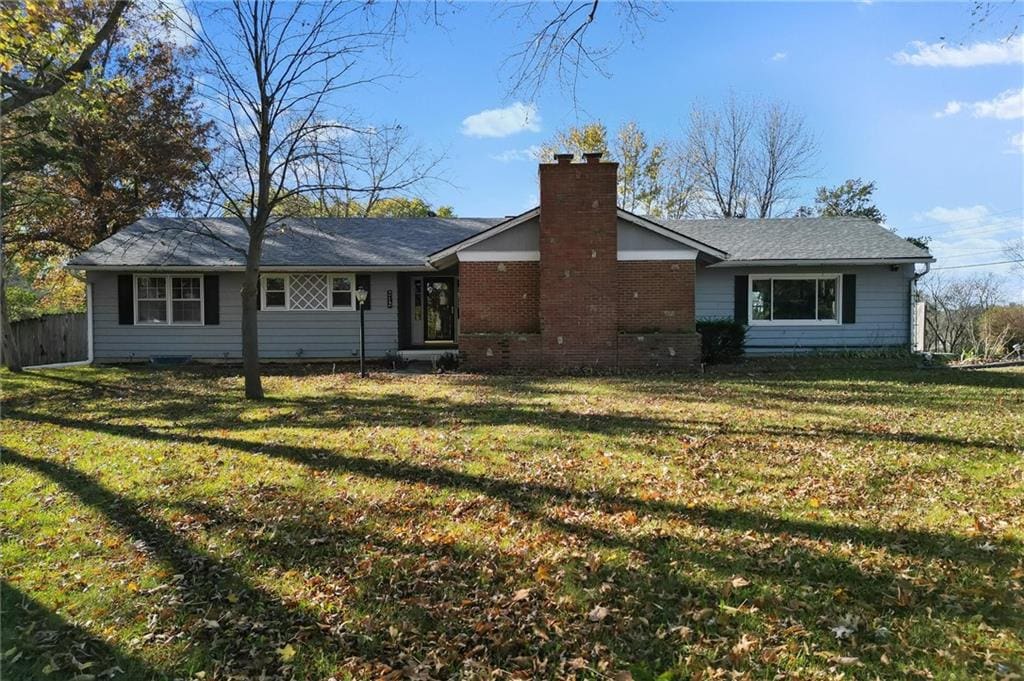 back of property featuring a lawn