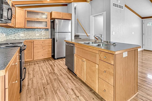 kitchen featuring decorative backsplash, a kitchen island with sink, sink, and black appliances