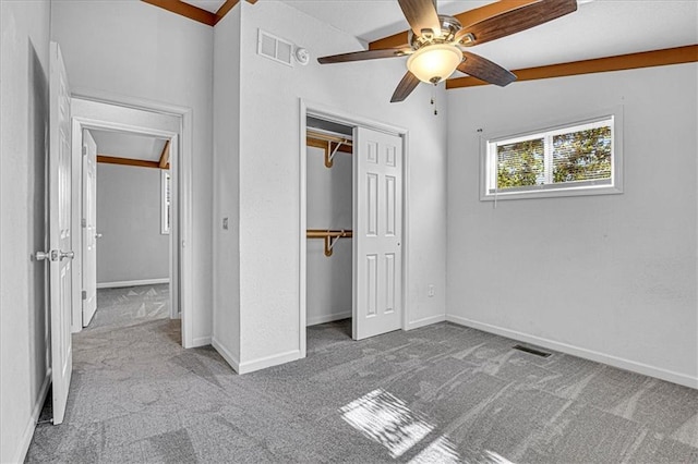 unfurnished bedroom featuring light carpet, a closet, vaulted ceiling, and ceiling fan