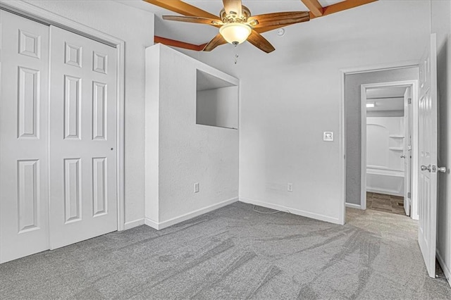 unfurnished bedroom featuring light carpet, a closet, and ceiling fan