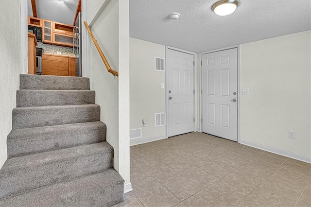 entrance foyer featuring a textured ceiling