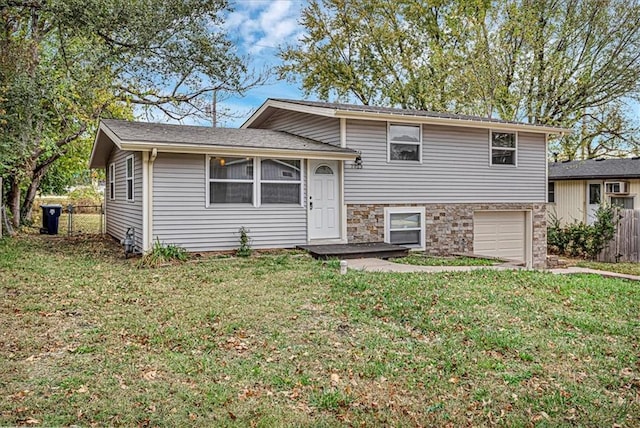 split level home featuring a garage and a front yard