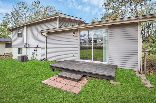 back of property with a lawn, cooling unit, and a wooden deck