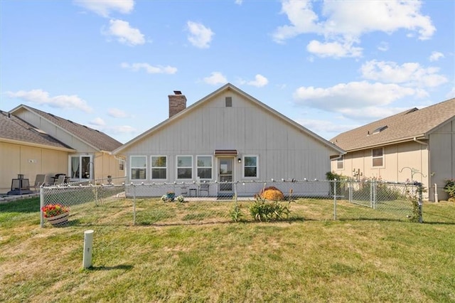 back of house featuring a yard