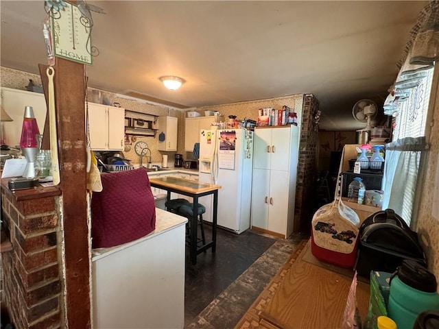 kitchen with white cabinets and white fridge with ice dispenser