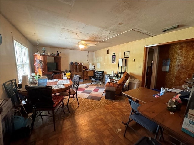 dining room with parquet floors and ceiling fan