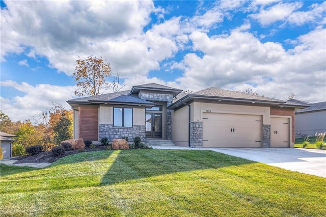 prairie-style house featuring a garage and a front lawn