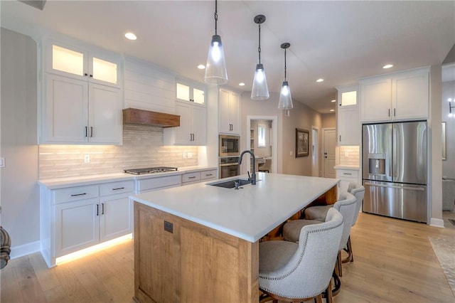 kitchen with white cabinets and appliances with stainless steel finishes