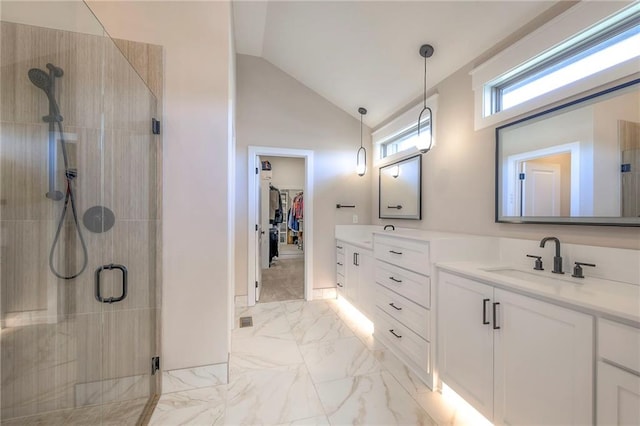 bathroom featuring walk in shower, vanity, and vaulted ceiling