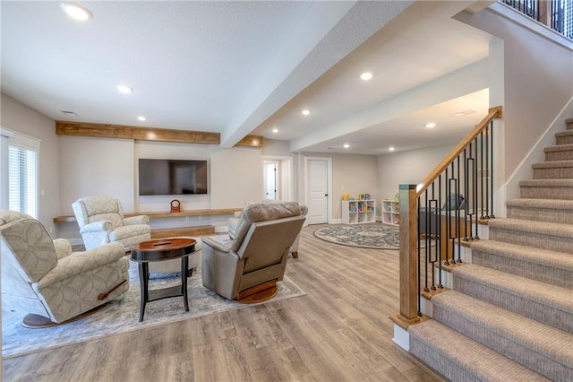 living room with beam ceiling and light hardwood / wood-style flooring