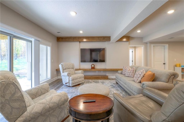 living room with hardwood / wood-style flooring and beamed ceiling