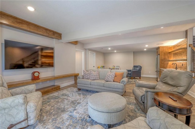 living room with hardwood / wood-style flooring and beamed ceiling