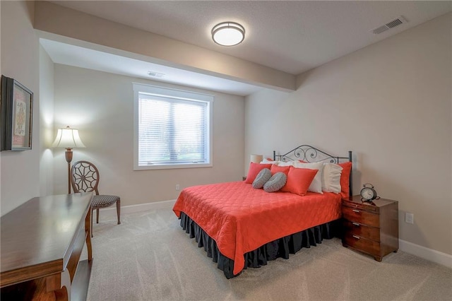 carpeted bedroom with beamed ceiling