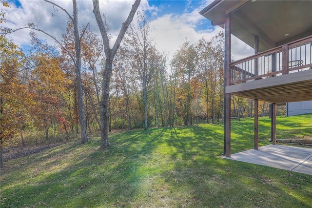 view of yard featuring a wooden deck and a patio