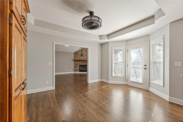 unfurnished living room with a fireplace and dark hardwood / wood-style floors