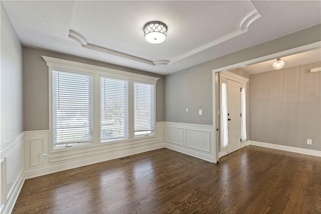 unfurnished room featuring a textured ceiling and dark hardwood / wood-style floors