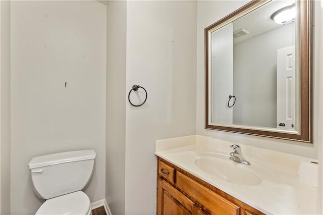 bathroom featuring toilet and vanity