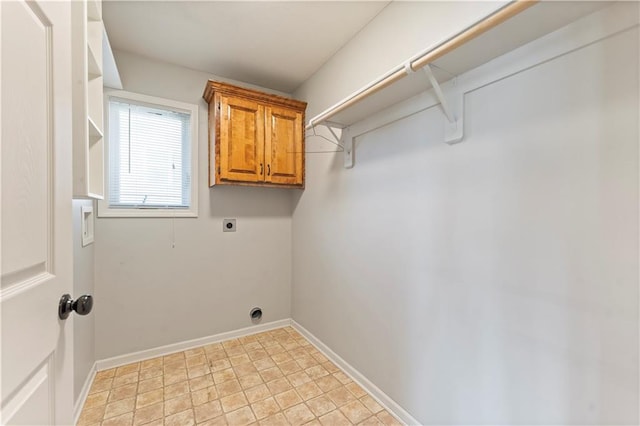 laundry area with cabinets and electric dryer hookup