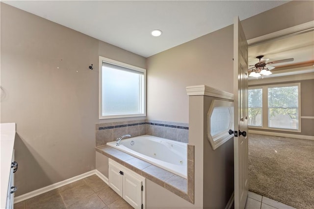 bathroom featuring vanity, ceiling fan, tile patterned floors, and a washtub