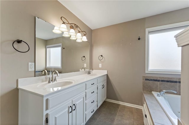 bathroom with vanity, a wealth of natural light, tiled bath, and tile patterned floors