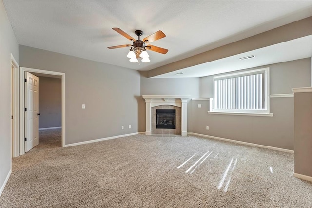 unfurnished living room featuring a fireplace, ceiling fan, and carpet flooring