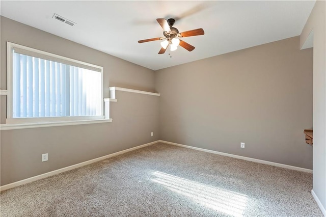 empty room with ceiling fan and carpet