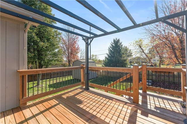 deck featuring a yard and a pergola