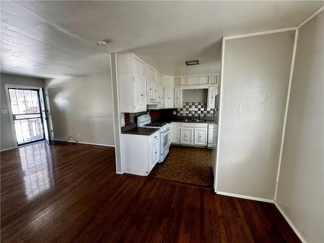 kitchen with white appliances, dark hardwood / wood-style floors, backsplash, white cabinetry, and sink