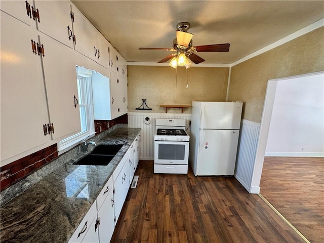 kitchen with white appliances, dark wood-type flooring, a sink, and white cabinetry