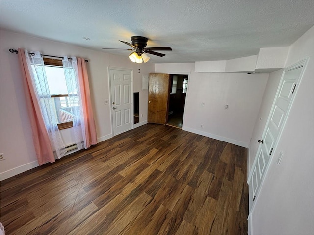 unfurnished bedroom featuring baseboard heating, dark wood-type flooring, ceiling fan, a textured ceiling, and baseboards