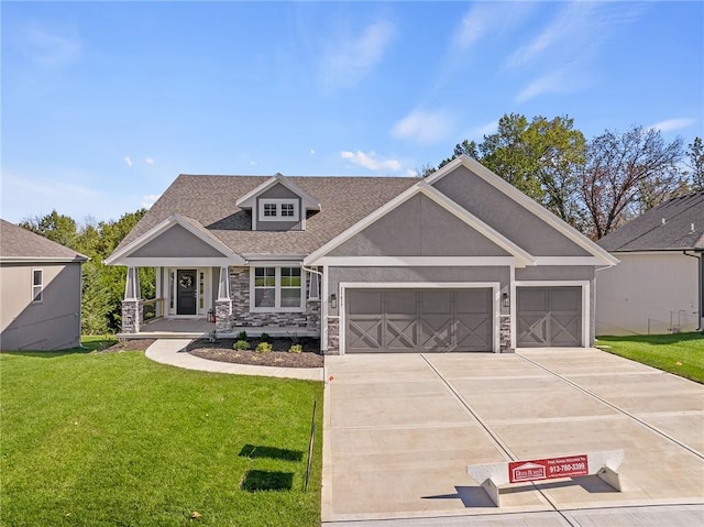 craftsman-style home featuring a porch, a front yard, and a garage