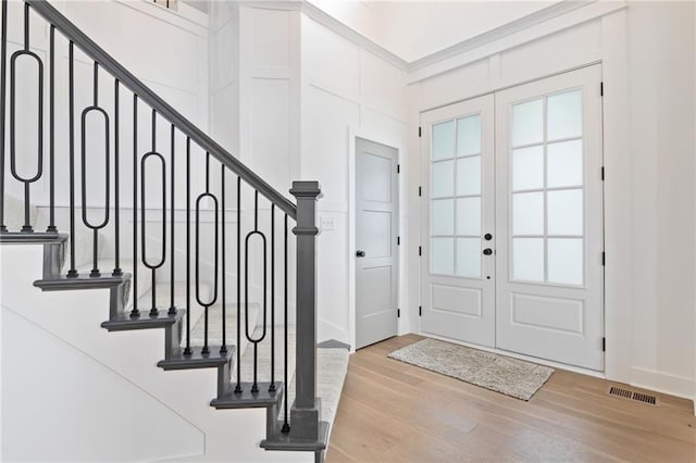 foyer entrance with french doors and light wood-type flooring